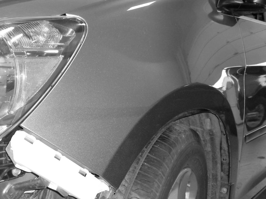 Close up after image of dent repair on front quarter panel