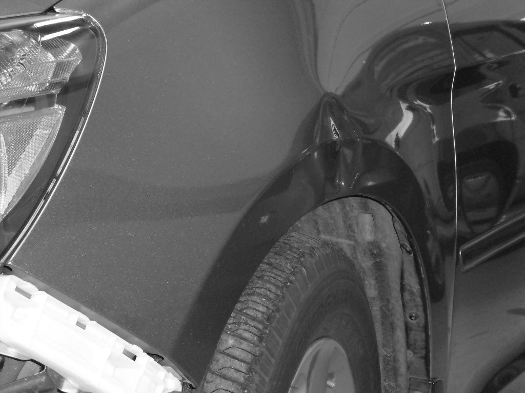Before close up image of dent on vehicle wheel well